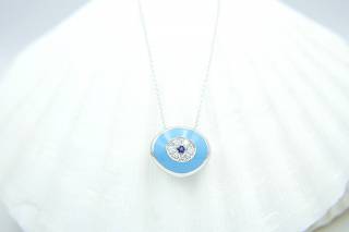 Pendant in evil-eye design with diamonds and sapphire